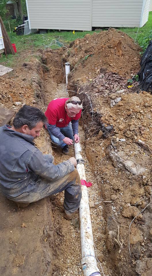 Davis Plumbing crew replacing a sewer line in an excavated trench