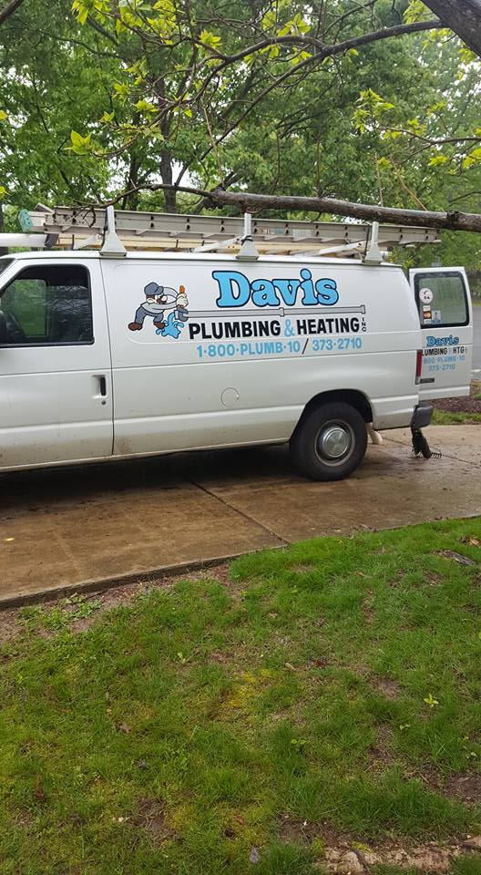 Davis Plumbing & Heating branded service van with ladder rack